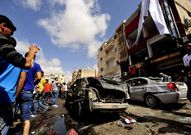 Habitantes de Bengasi observan el coche bomba.