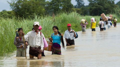 Varios residentes de aldeas de Myanmar, junto a la regin de Bago, intentan salvar sus cosas ante una gran inundacin.  