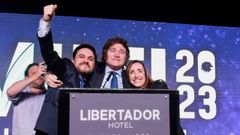 Milei celebra el triunfo junto con dos candidatos de su partido.
