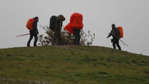 La lluvia  y el viento han sido hoy los protagonistas en Galicia. En la imagen, peregrinos en el monte do Gozo