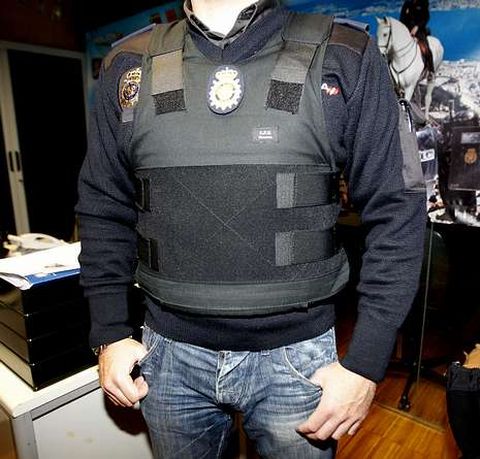 El polica nacional muestra el chaleco antibalas que le compr su madre para patrullar. 