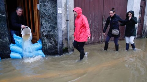 Vecinos de Sada sacando el agua de sus casas.