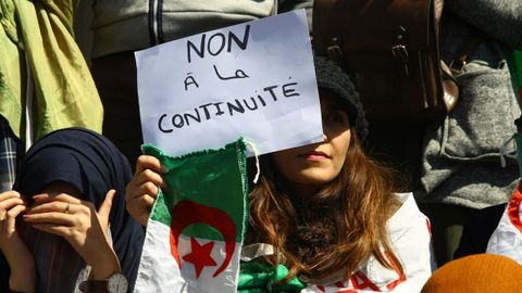 Protestas Argelia.Una mujer muestra una consigna contra la continuidad del régimen de Buteflika