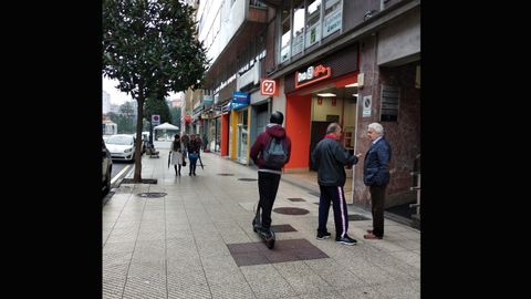 Un usuario recorre en patinete la calle Valentn Masip de Oviedo