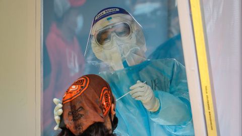Un sanitario hace la prueba a un mensajero en Manila, Filipinas