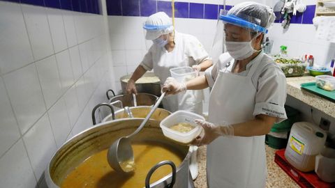 Trabajadores preparan alimentos para repartir dada la crisis derivada de la pandemia Covid-19, en un comedor comunitario de Bogotá, Colombia