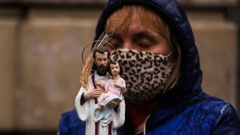 Una mujer carga una imagen de San Cayetano ayer durante la celebración de su día, en Buenos Aires