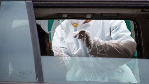 Un profesional sanitario realiza un prueba PCR en el covidauto de A Coruña