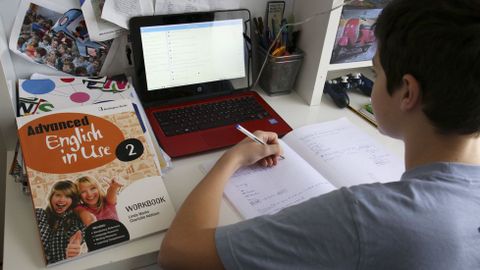 Un alumno gallego trabaja en su casa con un ordenador de la Xunta, dentro del programa E-Dixgal (libro digital)