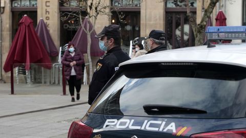 Agentes de la Policía Nacional vigilan en una plaza del centro de Monforte que los transeúntes cumplan las restricciones anticontagio que entraron en vigor este miércoles