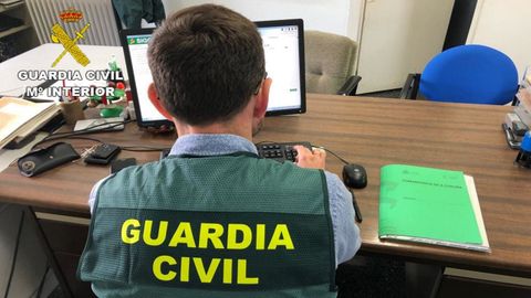 Imagen de archivo de un guardia civil frente a un ordenador