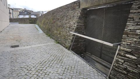 Rejilla de ventilación, sellados al fondo junto a la muralla y canalizaciones que provocan filtraciones en el yacimiento de la Domus do Mitreo