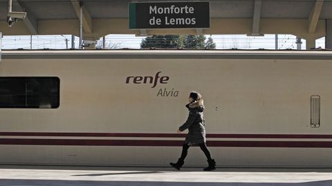 Una viajera pasa junto al tren Alvia Lugo-Madrid, detenido en la estación de Monforte