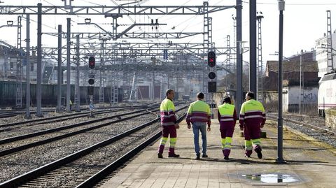 Empleados del taller ferroviario de Renfe en Monforte caminan desde la estación hacia su centro de trabajo