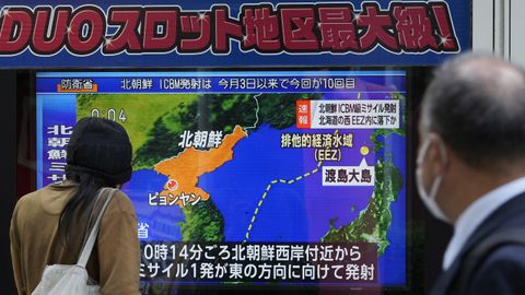 Viandantes contemplan en Tokio, Japón, la emisión de un informativo sobre el misil lanzado por Corea del Norte