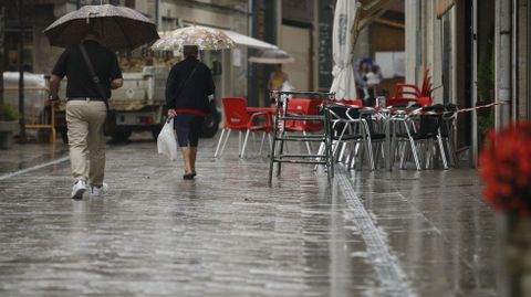 Paraguas y terrazas vaca en la calle Leonardo Rodrguez, durante las lluvias de esta maana