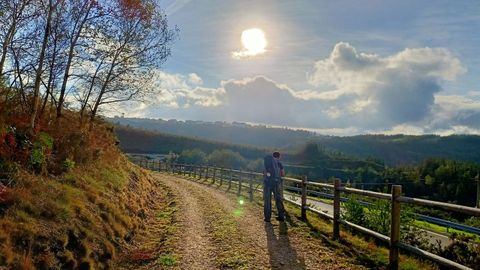 A pilgrim walks the Primitive Way in autumn, passing through A Fonsagrada.