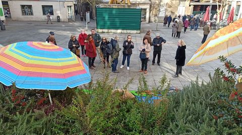 Un grupo de turistas valencianos hacen fotos de las comadres instaladas por Albores bajo dos sombrillas en la plaza de Espaa de Monforte