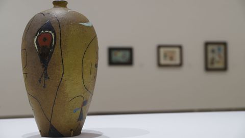 En primer plano, una de las piezas de cerámica que complementan la exposición pictórica.