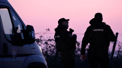 Serbian police officers at the checkpoint in Dubona, where a young man shot dead eight people from a car