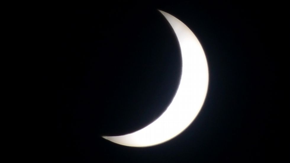 Un nio ve el eclipse desde Yakarta, Indonesia. 