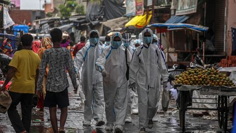 Trabajadores de la salud indios se van despus del chequeo mdico de los residentes de las zonas ms afectadas en Ambujwadi, Mumbai, India.