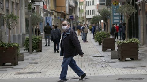 Un hombre pasea con mascarilla por Ribeira en el primer dia de la fase 1
