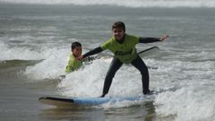 Sesin de surf de la Spot Surf School en la playa de Donios, en Ferrol, en verano