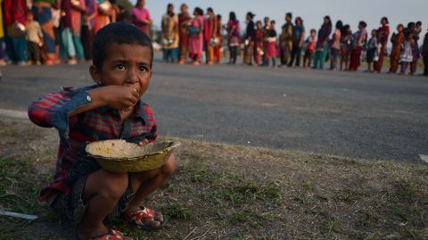 Un pequeo nepal come en uno de los campos de refugiados que las autoridades del pas han puesto a disposicin de los damnificados por el terremoto.
