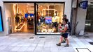 Dos turistas pasan frente a una tienda en rebajas en Oviedo