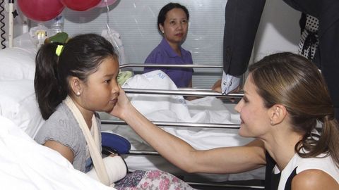 La Reina Letizia acaricia a una niña herida en el atentado durante la visita que los reyes realizaron ayer al Hospital del Mar