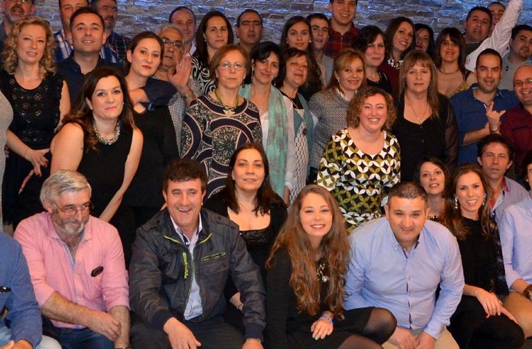 Paula, abajo en el centro, y su madre, Belén, la primera arriba a la izquierda, junto a otros vecinos de San Cremenzo en la comida anual de la parroquia, como siempre alegre, celebrada en Buño hace dos meses.