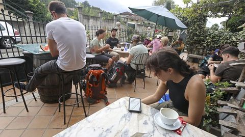 Peregrinos haciendo el camino de Santiago recalan en el café bar Oasis en Barosa, Barro