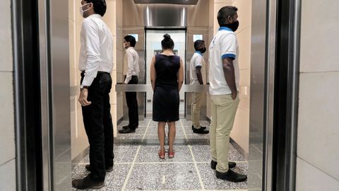 En un ascensor en el World Trade Center de Sri Lanka se observan marcas que establecen cómo distanciarse. Las empresas han reabierto estos días