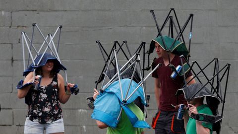 Espectadores de la Frmula 1 se protegen de la lluvia con sus sillas