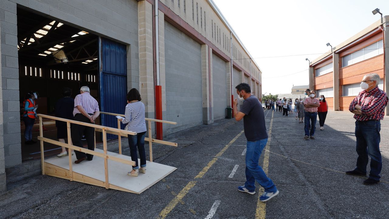 V�deo de las elecciones en Burela, con colas para votar.Demetrio ayuda a Alsira a colocarse la mascarilla antes de entrar en el colegio electoral en la antigua rectoral de Erbecedo.