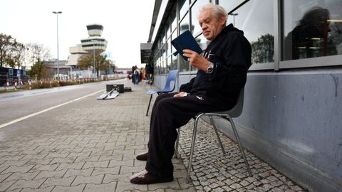 Un refugiado ucraniano consulta su telfono en el antiguo aeropuerto berlins de Tegel, transformado por las autoridades alemanas en un centro de acogida