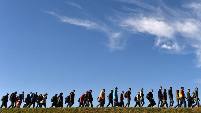 Emigrantes caminan hacia un primer punto de registro de la policía federal alemana después de cruzar la frontera austro-alemana en la pequeña localidad bávara de Simbach, el sur de Alemania