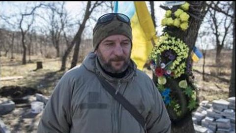 Military chaplain Maksim Bervinov builds a small monument in Lilac Park in Kherson.