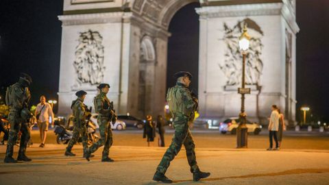 French soldiers guard the area near the Arc de Triomphe in Paris, France.