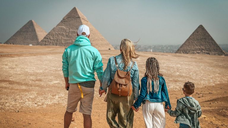 Family of four exploring the Giza Pyramids