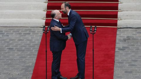 Philippe abraza a su predecesor Cazeneuve, en el traspaso de poderes en Matignon.