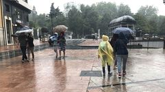 Los turistas se protegen de la lluvia en Oviedo.Los turistas se protegen de la lluvia en Oviedo