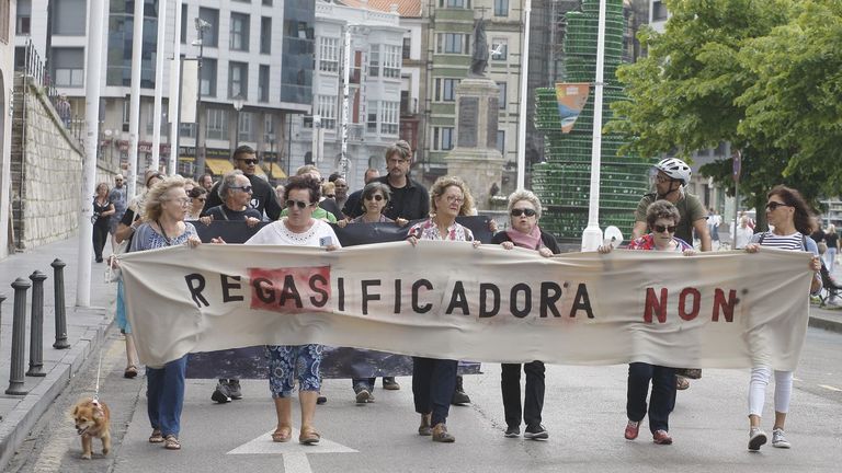 Decenas de personas se manifiestan contra la puesta en marcha de la regasificadora de El Musel en Gijón.