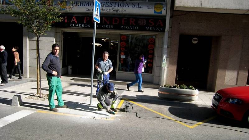 Operarios retirando bolardos en sarria