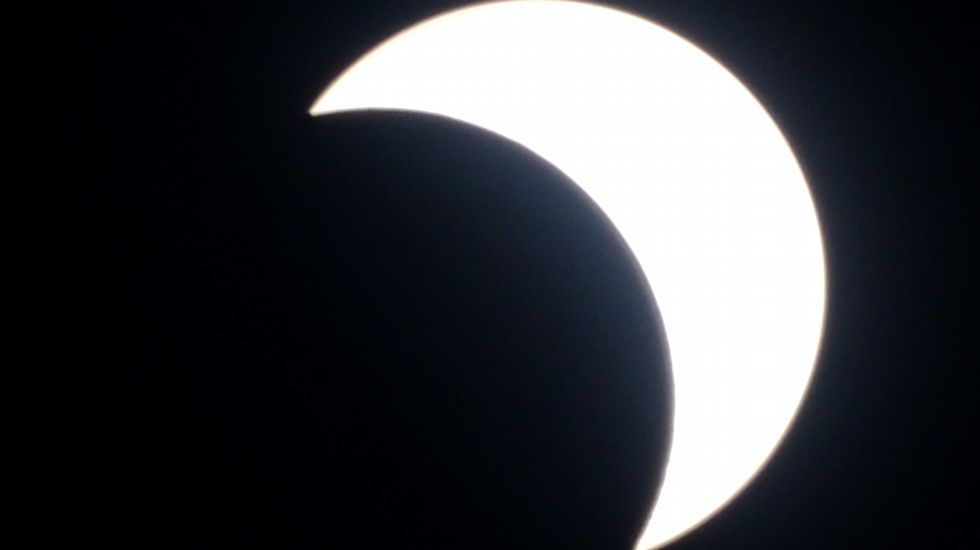 Un nio ve el eclipse desde Yakarta, Indonesia. 
