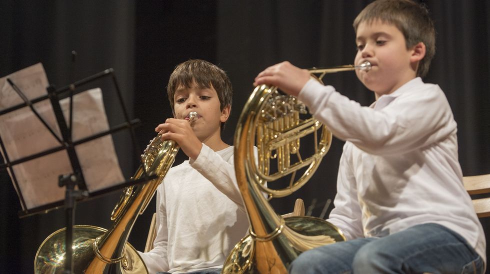 Un coche peque�o pasa a duras penas por la curva que est� entre una casa y la iglesia. 