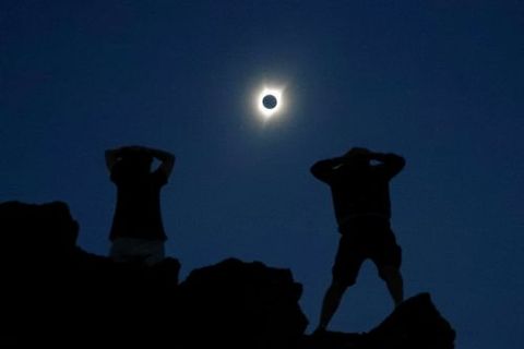 Los entusiastas Tanner Person y Josh Bliek, ambos de Vacaville, California, observan el eclipse solar total